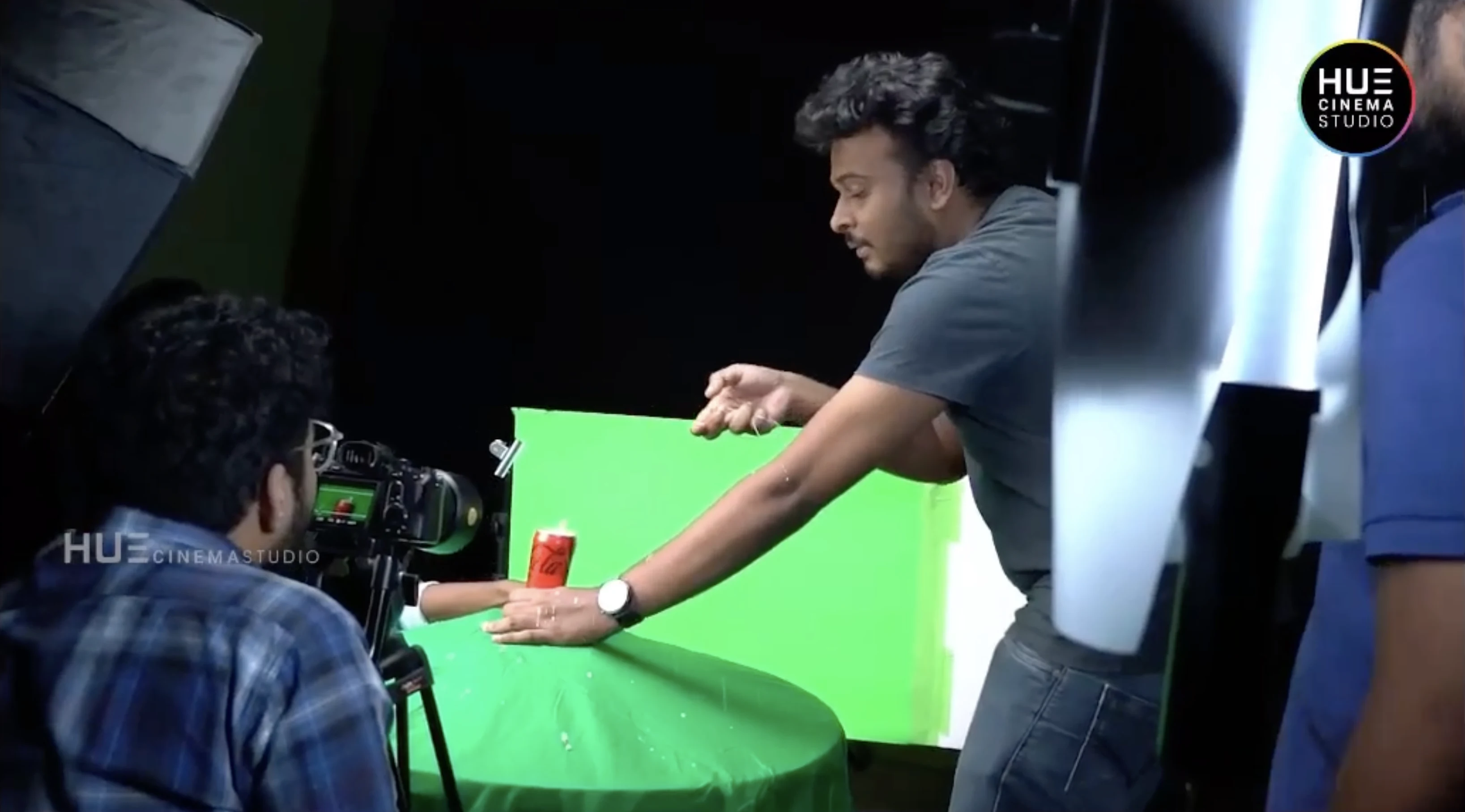 Director Haran Reddi opening a Coca-Cola can on set for the cinematographer during the Alkor Cyber Space soft drinks b-roll shoot, Hue Cinema Studio.