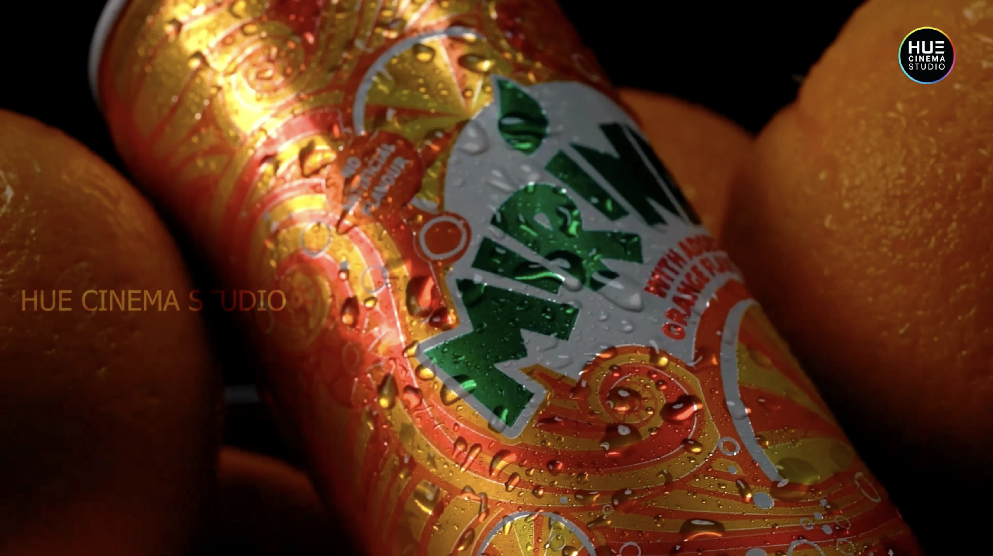 A chilled, condensation-covered Mirinda can resting among fresh oranges, from the Alkor Cyber Space soft drinks b-roll showreel by Hue Cinema Studio.